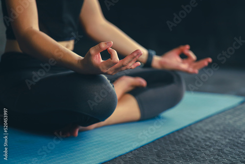 woman practice yoga meditation exercise in gym, beautiful female sitting on mat for relaxed yoga posture in the morning , exercise at park, mental health care,healthy and sport