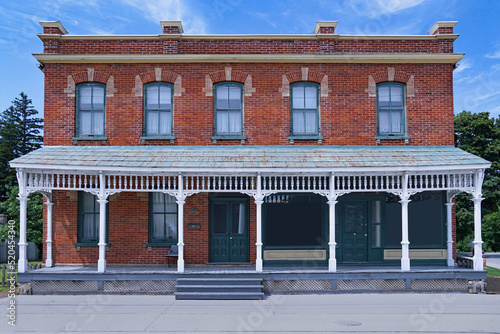 Fotografi Old fashioned brick building with full width front porch, originally a rural gen