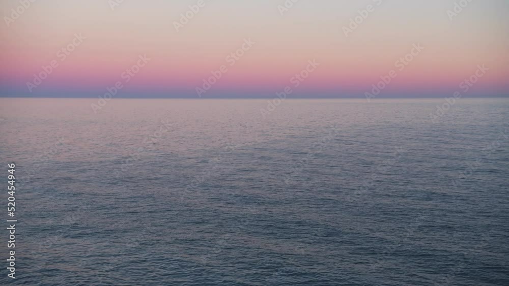 Pink Purple Colour Sunset Ocean Background with Calm Sea Water, Horizon and Orange Sky with Copy Space for Text, Costa del Sol, Spain Pink Purple Colour Sunset Ocean Background with Calm Sea Water, Horizon and Orange Sky with Copy Space for Text, Costa del Sol, Spain