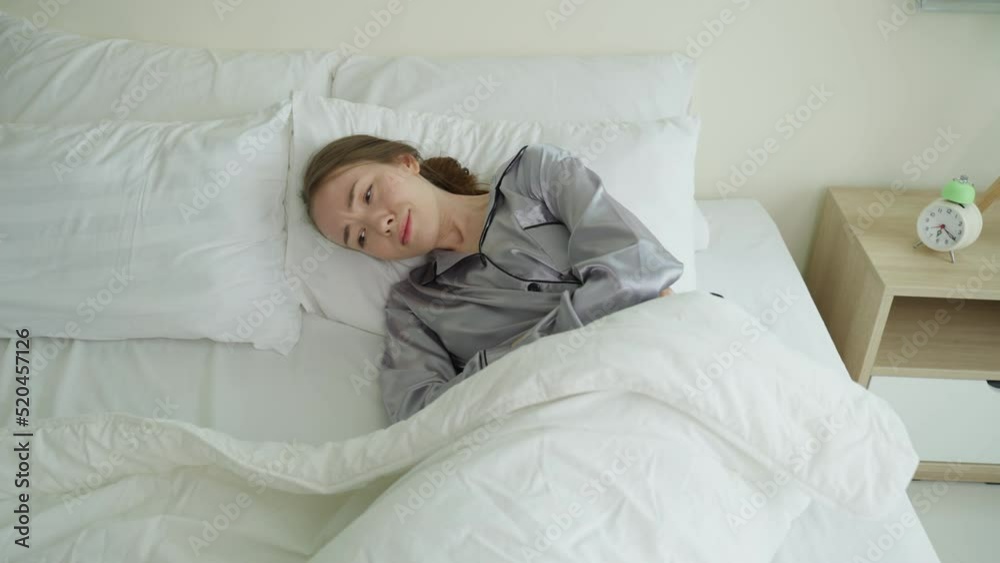 Caucasian beautiful sick girl in pajamas get up from sleep in bedroom. Caucasian beautiful sick girl in pajamas get up from sleep in bedroom.