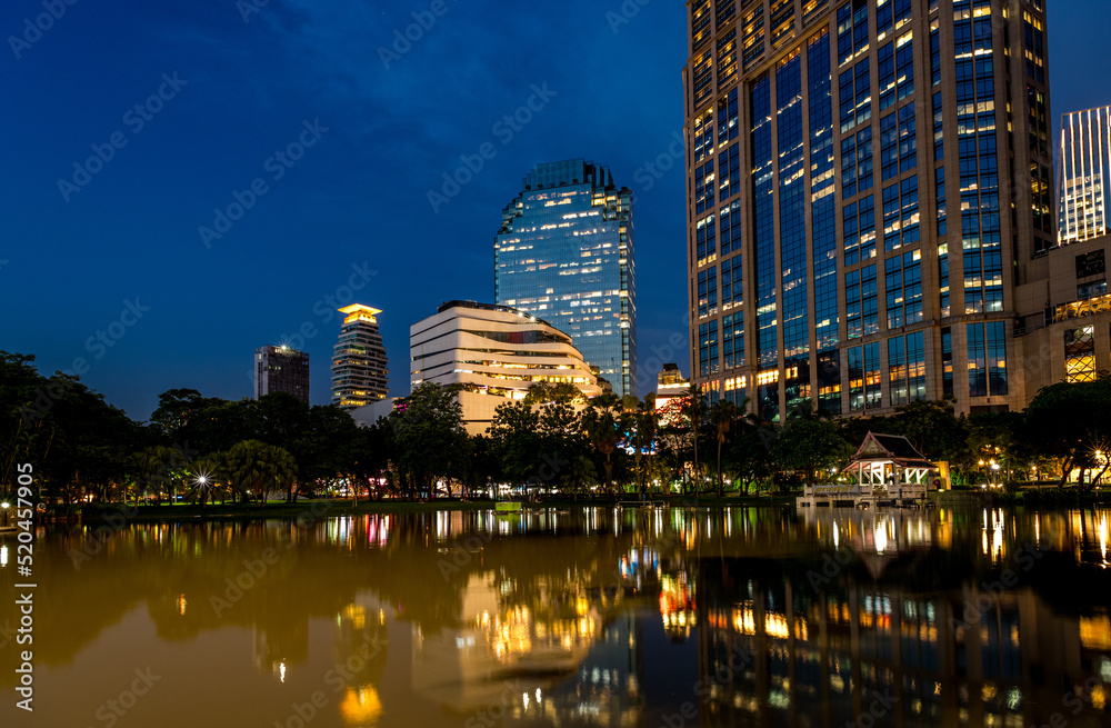 Naklejka premium Reflections in a lake at Queen's Park (Benchasiri Park) in downtown Bangkok