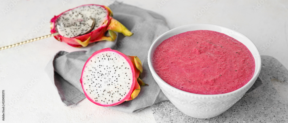 Bowl with dragon fruit smoothie on light background Bowl with dragon fruit smoothie on light background