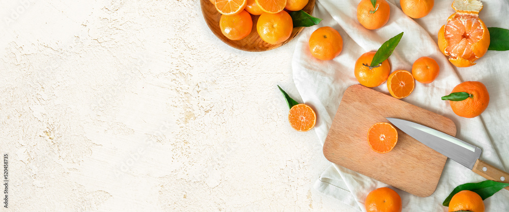 Composition with sweet tangerines on light background with space for text