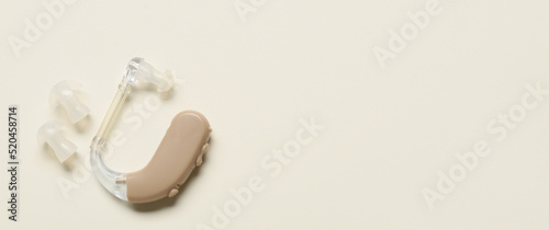 Hearing aid on light background with space for text