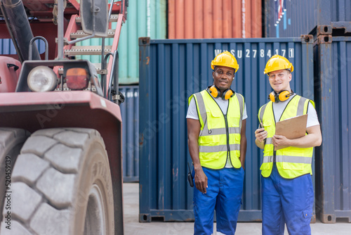 Portrait of Caucasian worker and African man work in container port. 