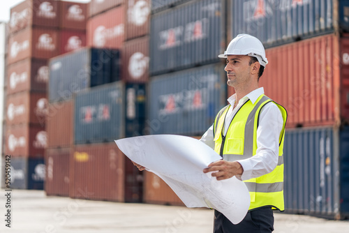 Caucasian handsome man engineer worker work in container port terminal