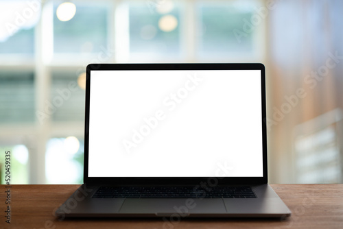laptop with screen on wooden table	