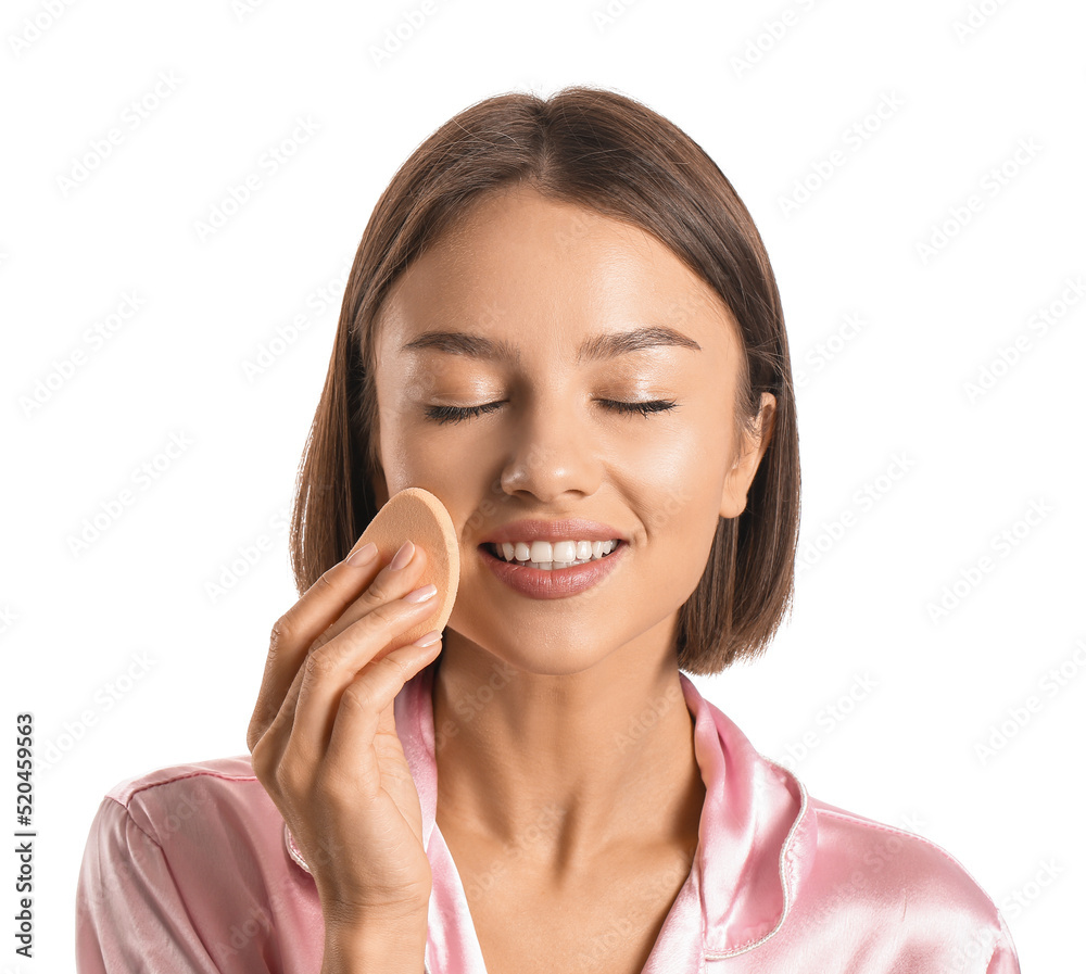 Pretty young woman with makeup sponge on white background Pretty young woman with makeup sponge on white background