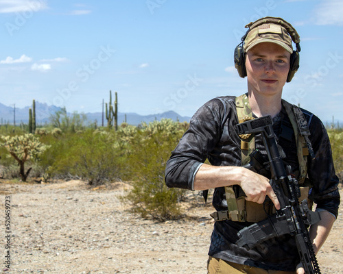 Patriotic Man looking at camera with straight face while holding ar15 pistol gun