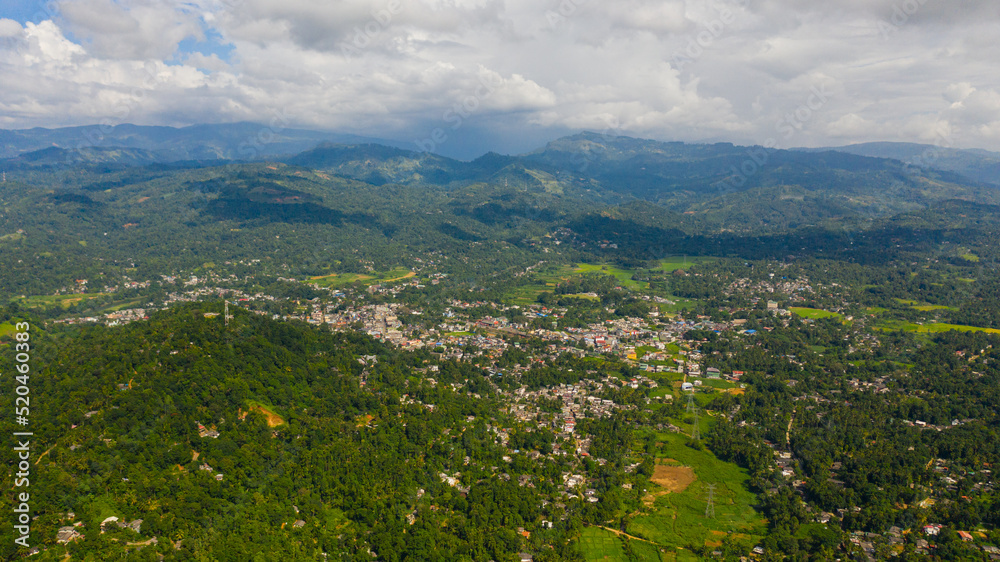 A town and agricultural fields in a mountain valley among the mountains. Gampola Town, Sri Lanka.