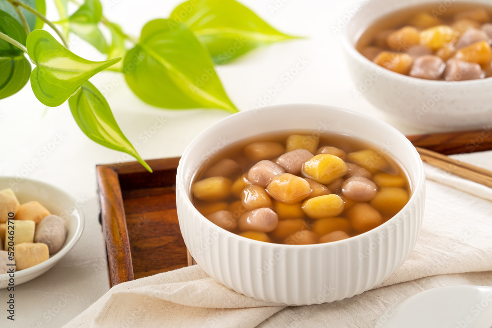 Delicious sweet taro ball soup in a white bowl for serving. Delicious sweet taro ball soup in a white bowl for serving.