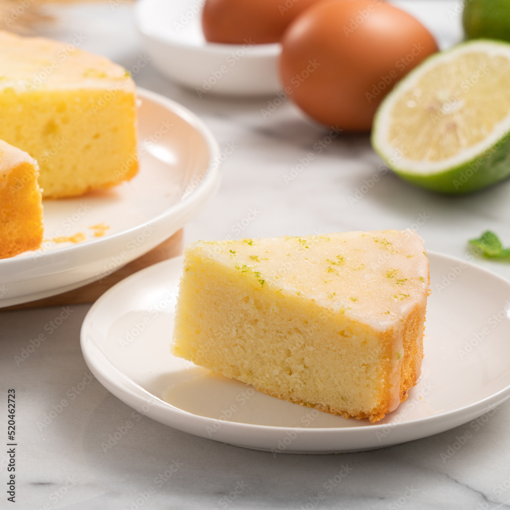 Delicious Lemon Glazed Pound Sponge cake on white marble table background. Delicious Lemon Glazed Pound Sponge cake on white marble table background.
