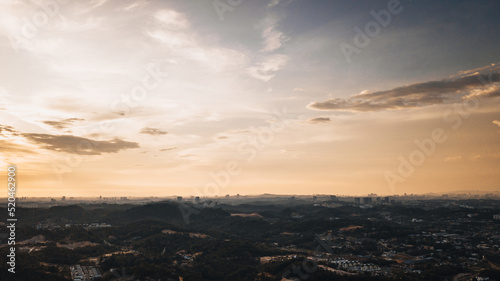 Amazing aerial view on the orange sky, sunset sun and clouds. © ellinnur