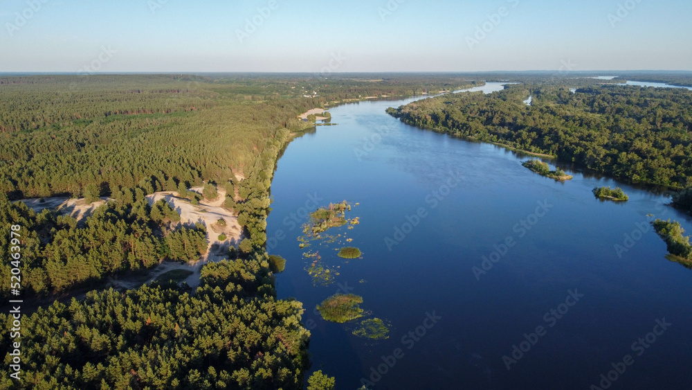 the Dnieper river flows among the forests and fields, ukraine filming from a drone. view from above