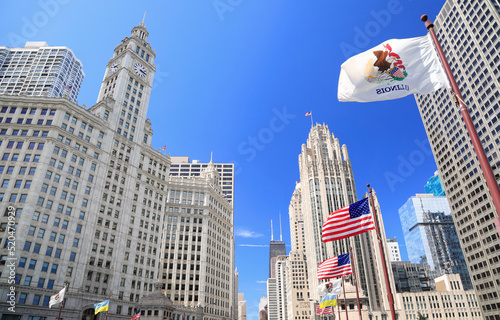 Wrigley Building and Tribune Tower on Michigan Avenue with Illinois flag on the foreground in Chicago, USA photo