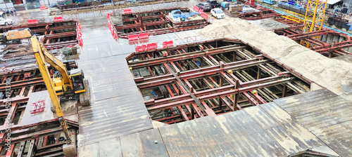 Building construction site in the city. Underground foundation for high-rise building. Metal structure and iron beam for building construction.