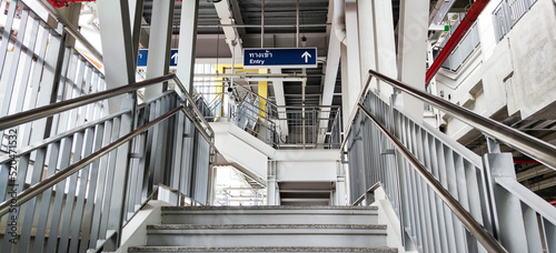Landscape view of modern structure of sky train platform. City mass transit stairs and structure of the station platform. Staircase to the sky train station.