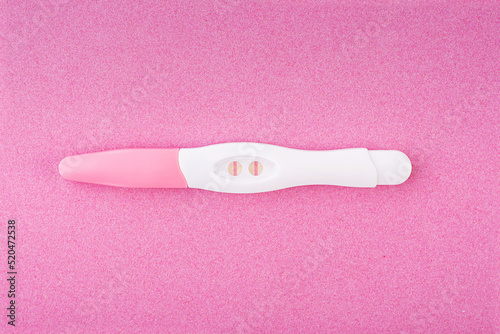 Positive pregnancy test isolated on pink background