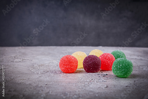 Colorful marmalade on grey background. Delicious jujube balls.