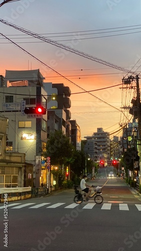 The sunset at the crossings of old downtown Tokyo, beautiful orange gradation, Nezu year 2022 July 30th