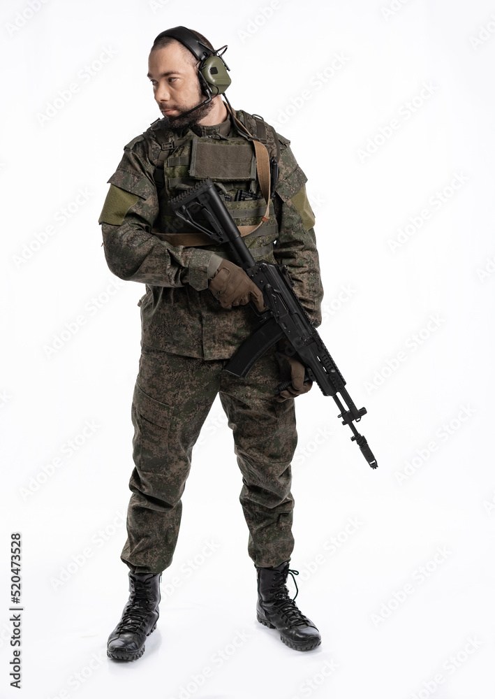 soldier in the studio on a white background. a man in military uniform with a rifle or machine gun. military or airball player soldier in the studio on a white background. a man in military uniform with a rifle or machine gun. military or airball player