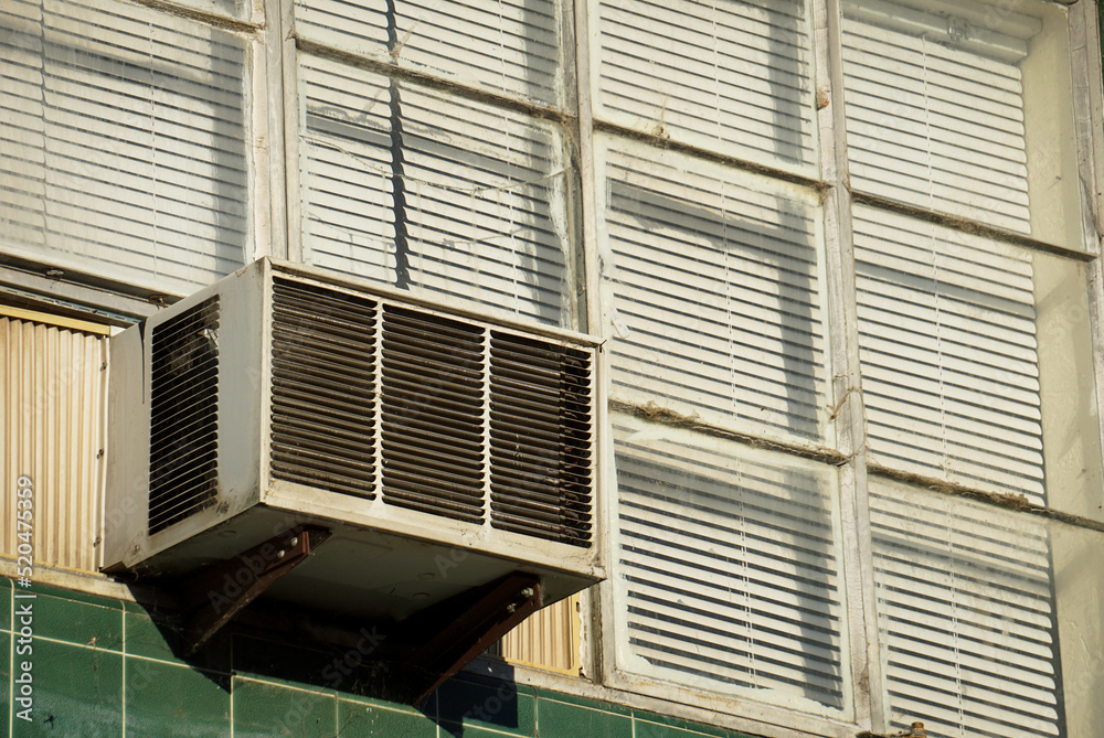 Fototapeta premium Old air conditioner unit in building window 