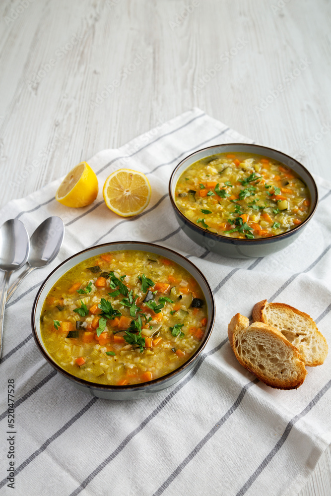 Homemade fresh lemon rice soup in a bowl, low angle view. Copy space. Homemade fresh lemon rice soup in a bowl, low angle view. Copy space.