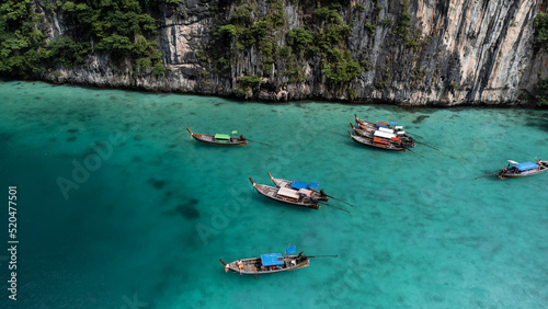 Long boats in paradise. Crystal clear waters of the Phi Phi islands. Travel to Thailand