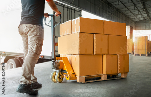 Workers Unloading Packaging Boxes on Pallet in Warehouse. Loading Cartons, Cardboard Boxes. Shipping Warehouse. Shipment Boxes. Storehouse. Cargo Supplies Warehouse Logistics. 