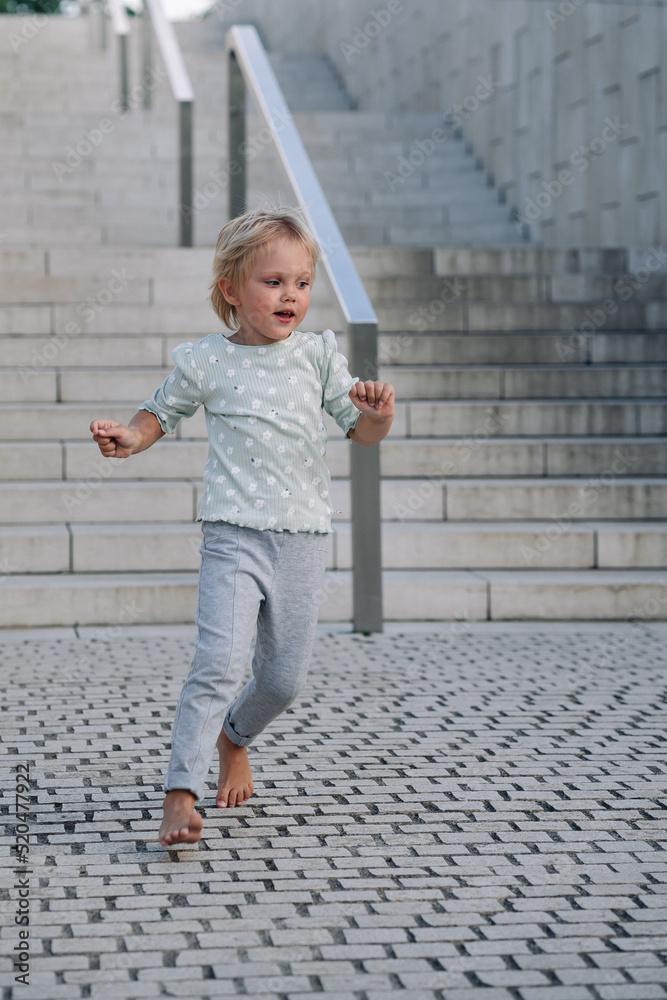 Portrait of child 4 years old enjoying and running down stairs Portrait of child 4 years old enjoying and running down stairs