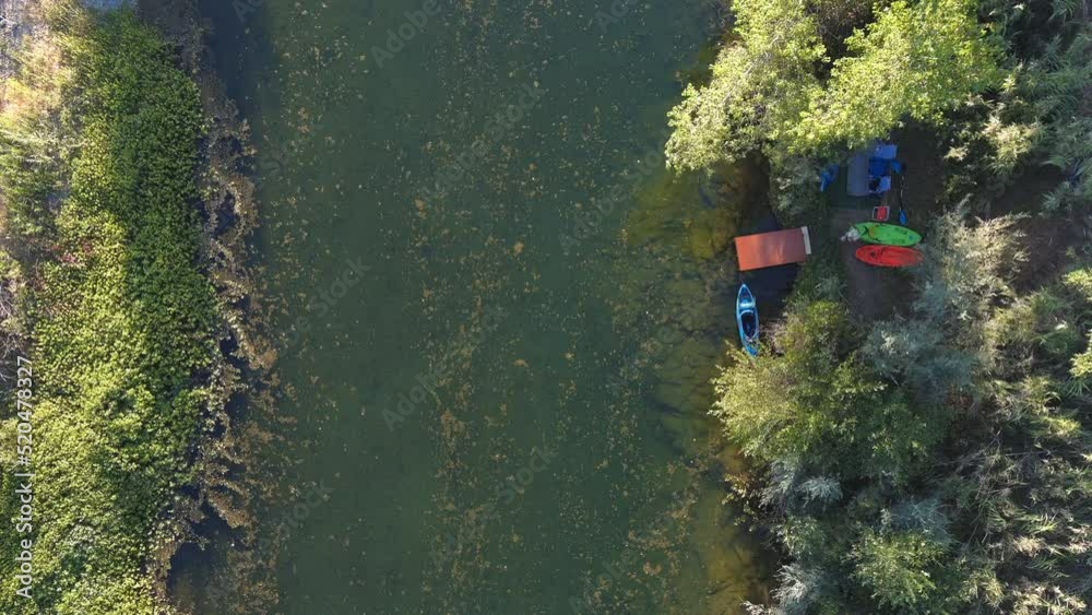 Man Launches Kayak Boat And Goes Kayaking On The Russian River In Northern California, USA. aerial top-down Man Launches Kayak Boat And Goes Kayaking On The Russian River In Northern California, USA. aerial top-down