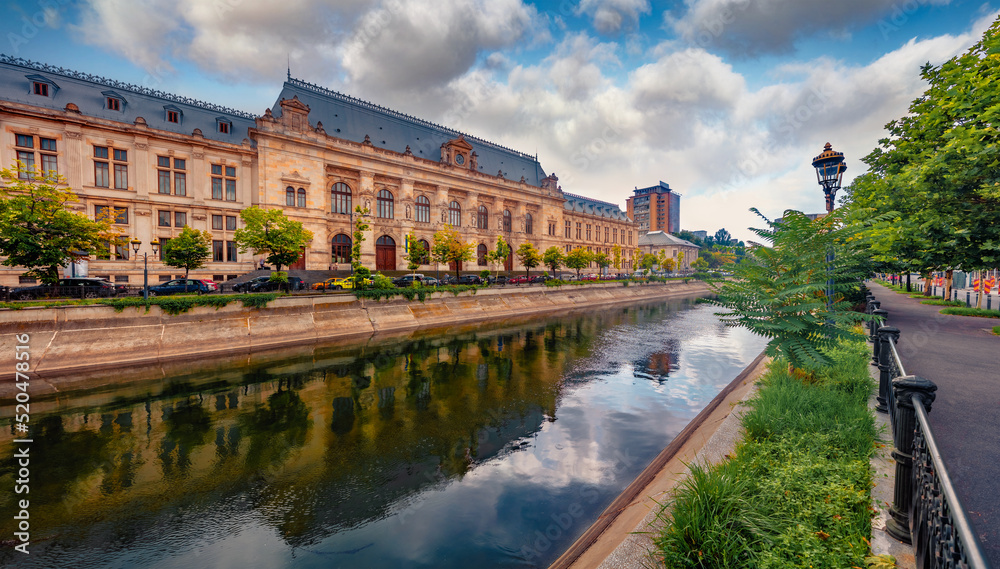 Fototapeta premium Captivating summer view of Court of Appeal Building on the shore of Dambovita river. Attractive morning cityscape of Bucharest city - capital of Romania, Europe. Traveling concept background.