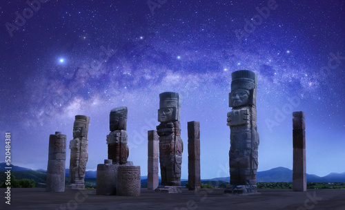 Toltec sculptures in Tula against background of starry sky, Mexico