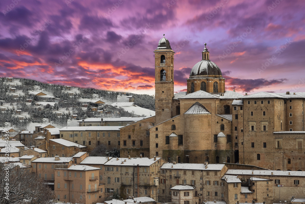 View of beautiful winter sunset over Urbino town in the Marche region