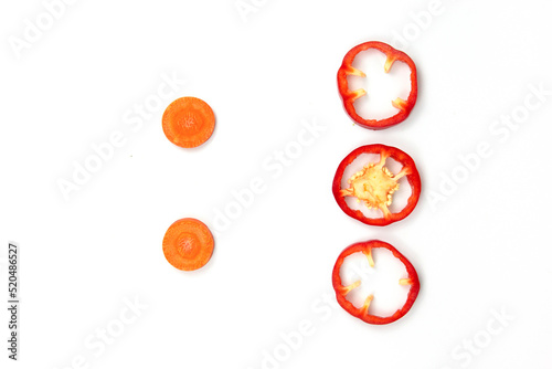 Red Fresh bell pepper and carrots sliced isolated on white background
