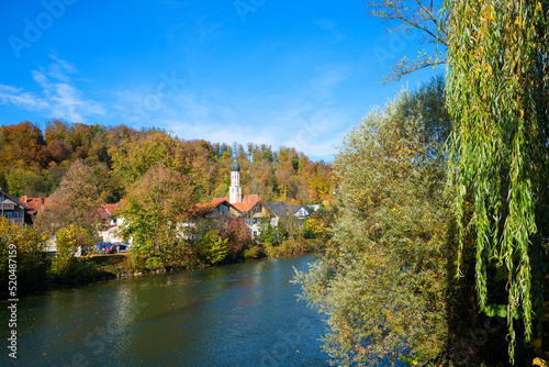 pictorial autumn landscape Wolfratshausen, Loisach river and St. Andreas church. upper bavarian