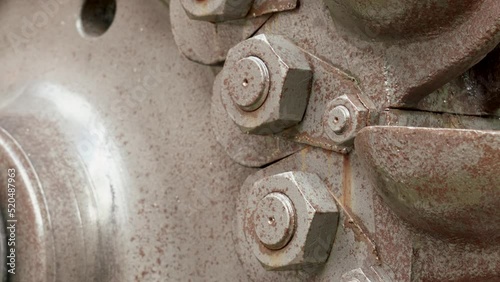 Heavy industry equipment. Metal rusty bolts and nuts of an engineering hidro technical gear close-up photo