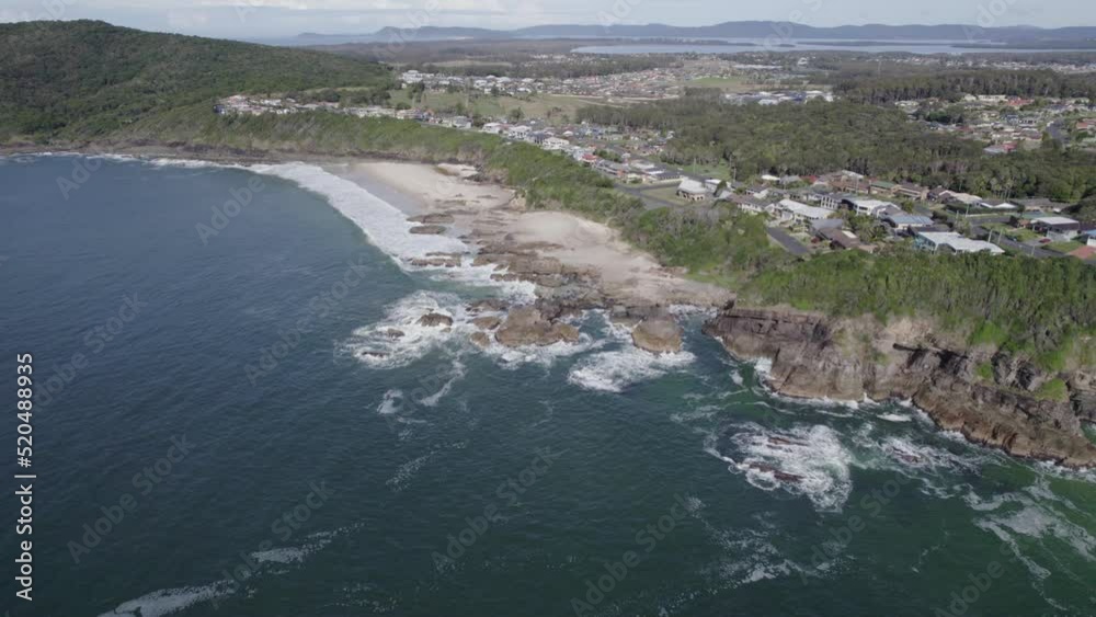 Rocky Burgess Beach And Coastal Town Of Forster On Vegetation-covered Bluff In New South Wales, Australia. aerial drone Rocky Burgess Beach And Coastal Town Of Forster On Vegetation-covered Bluff In New South Wales, Australia. aerial drone
