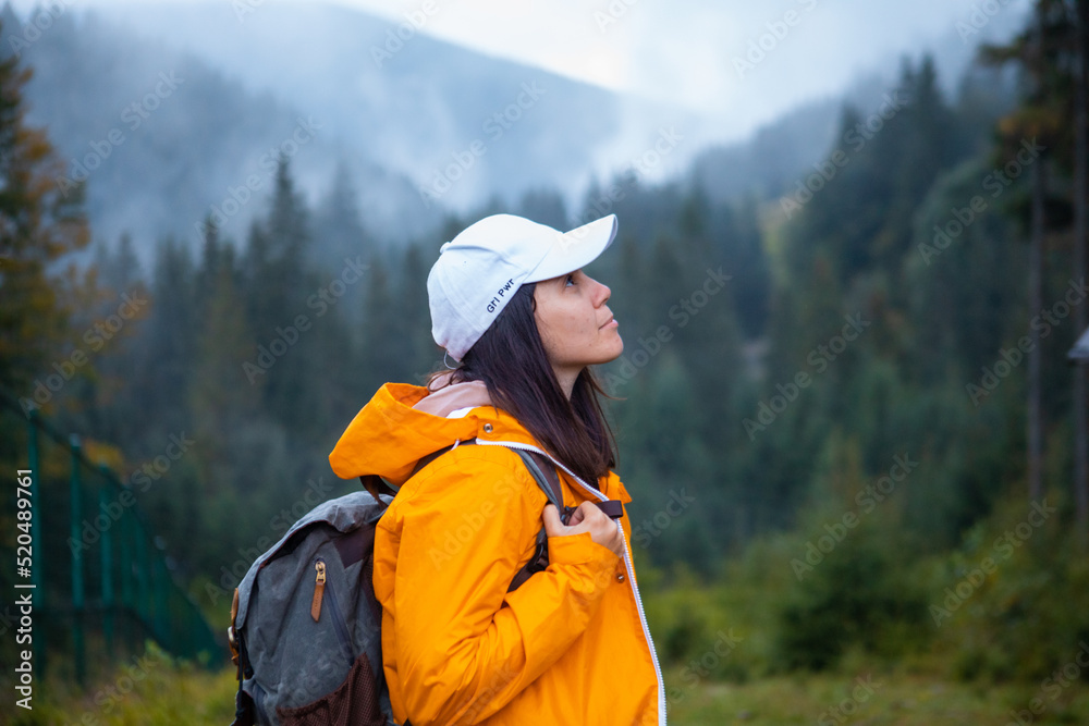 woman in yellow raincoat hiker in autumn mountains woman in yellow raincoat hiker in autumn mountains