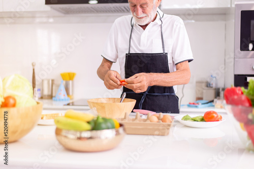 Senior men cooking meal at home in the morning,Elderly healthy food concept,Preparing breakfast
