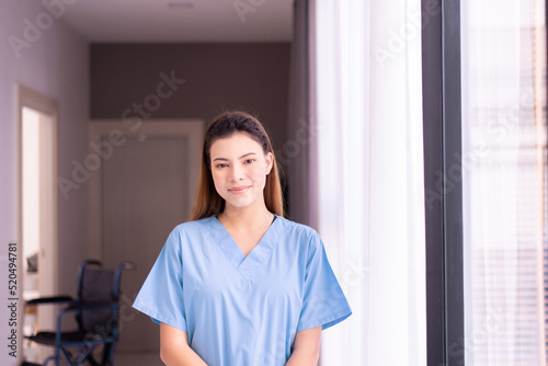 Portrait of beautiful nurse standing and smiling in a nursing home © gballgiggs