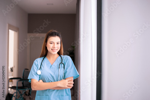 Portrait of beautiful nurse standing and cross arms in a nursing home
