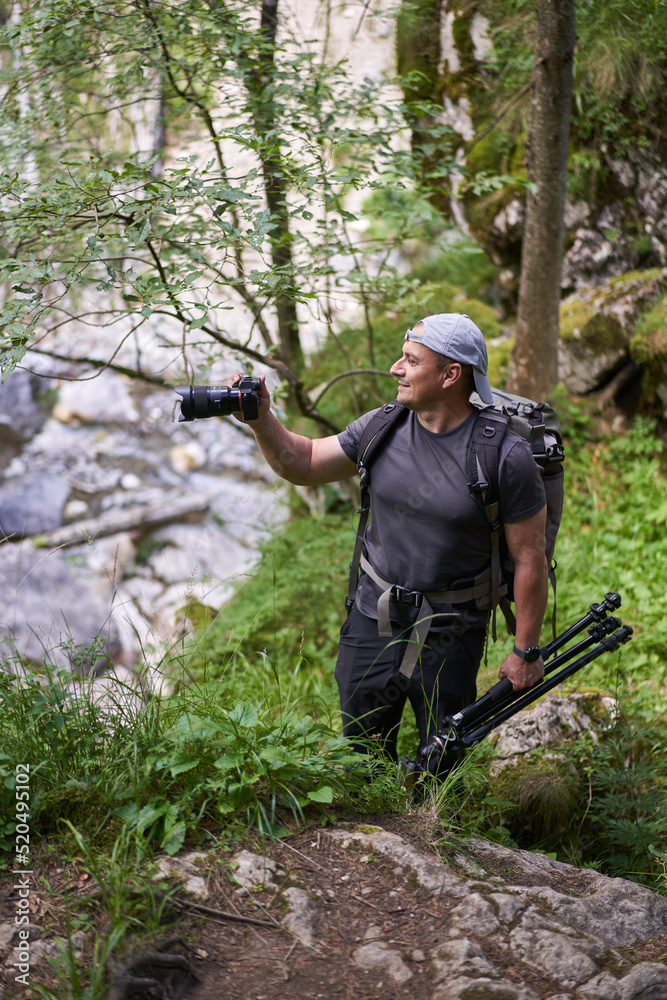 Nature photographer hiking in the forest