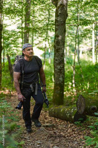 Nature photographer hiking in the forest