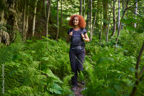 Woman hiking on a trail in the forest