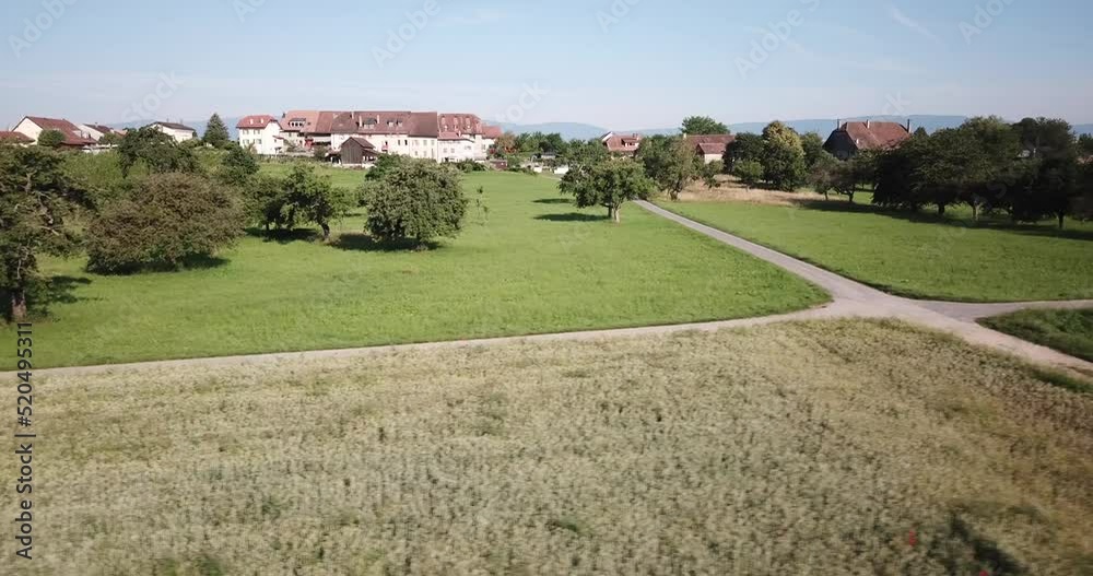 Roads and intersection in the middle of fields, Swiss countryside, Vaud, drone view Roads and intersection in the middle of fields, Swiss countryside, Vaud, drone view