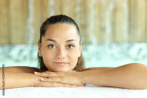 Beauty woman looking at camera in spa pool