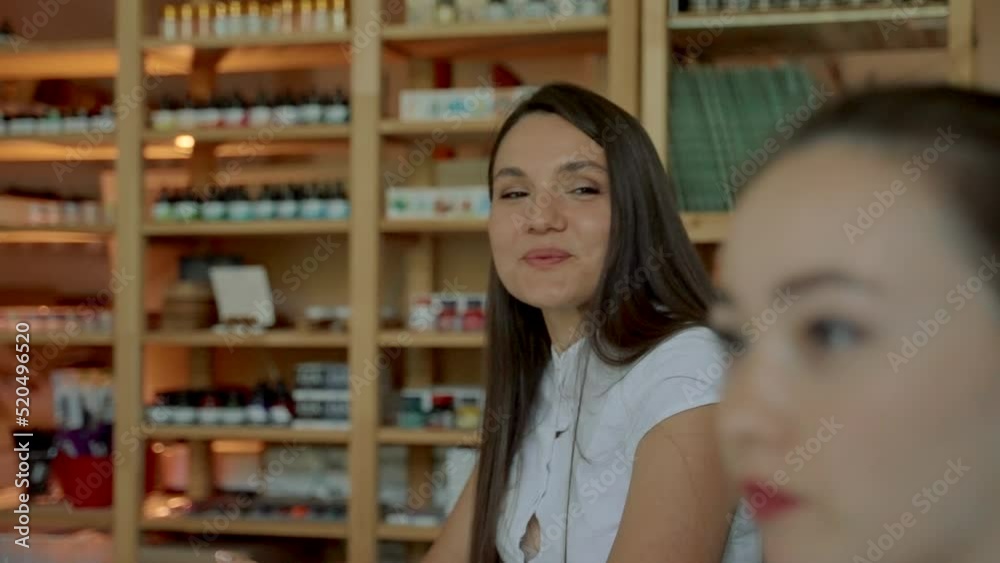 Young women communicate with mentor at business meeting. Diligent ladies answer questions sitting at desks in audience closeup slow motion Young women communicate with mentor at business meeting. Diligent ladies answer questions sitting at desks in audience closeup slow motion