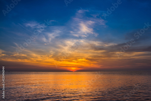 sunset sky with dramatic sunset clouds over the sea. Beautiful sunrise over Ocean © meen_na