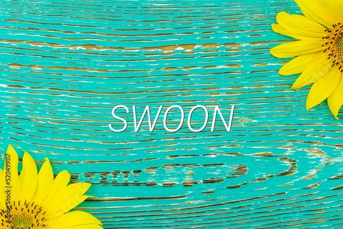 SWOON - text, yellow flowers, sunflowers, wooden background (copy space).